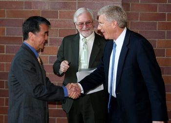 Li (left) meets Poneman before the presentation as Brase looks on.